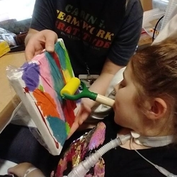 child painting with their mouth